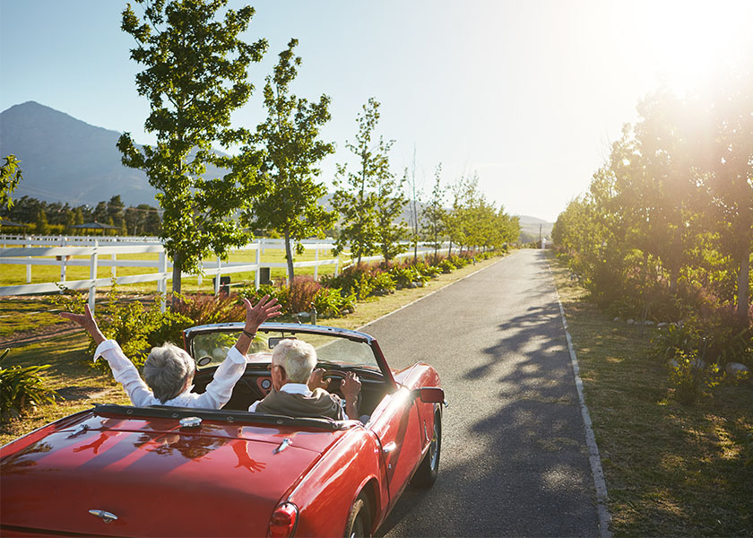 Retired couple enjoying ride in convertible