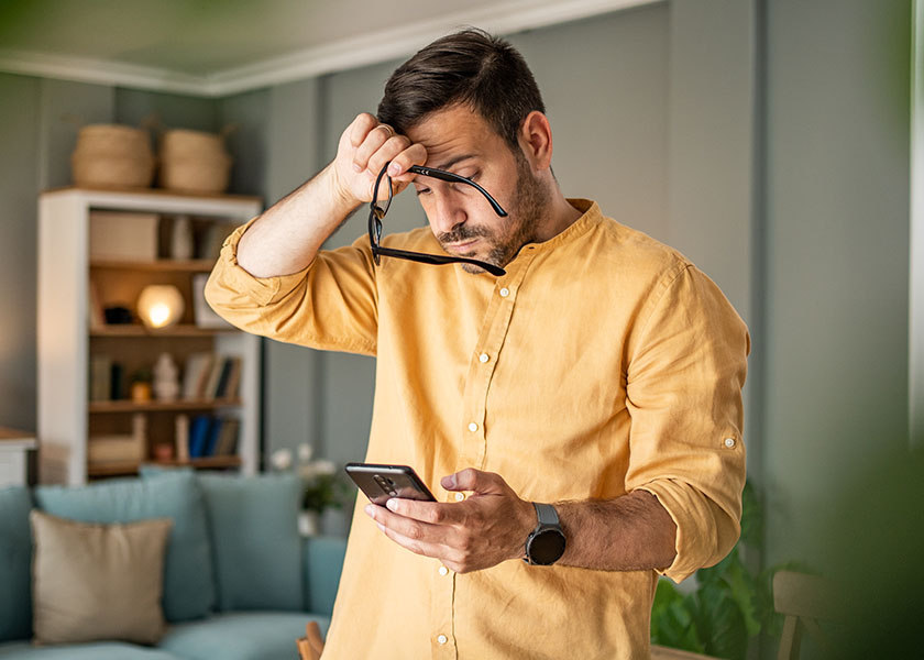 Man reading bad news on phone