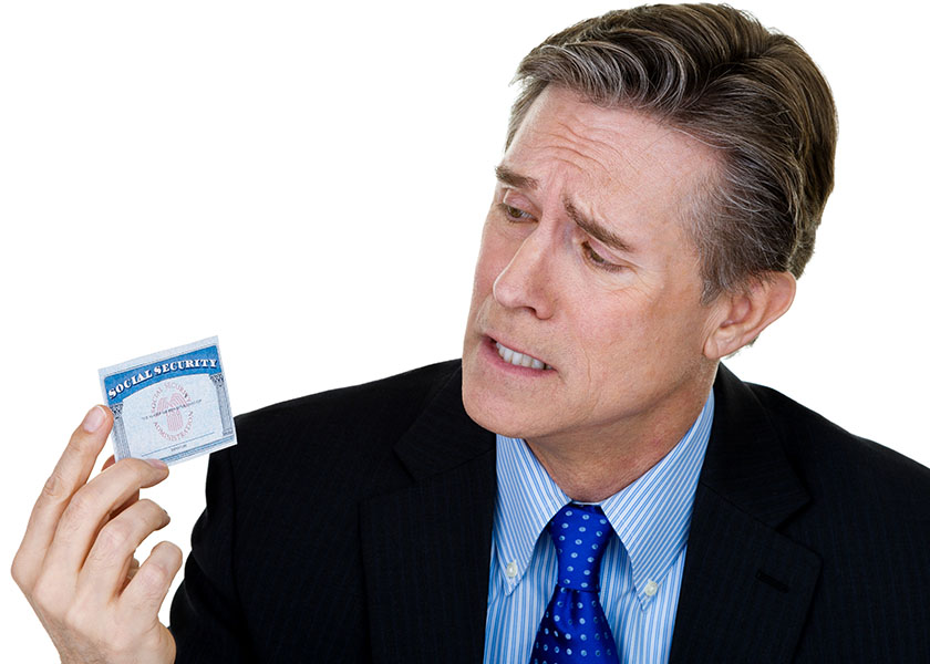 Quizzical man holding Social Security card